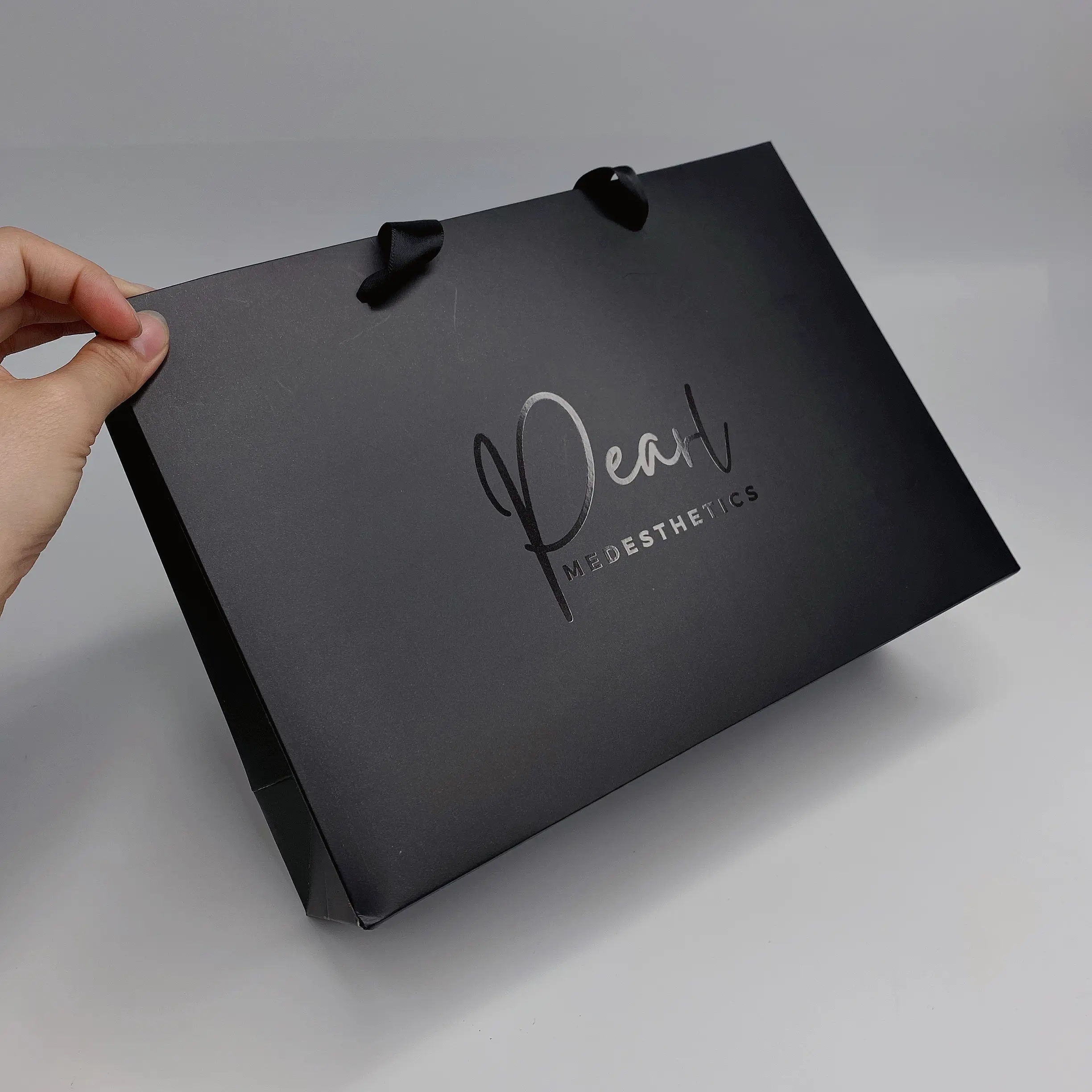 Luxury black paper bag with ribbon handle